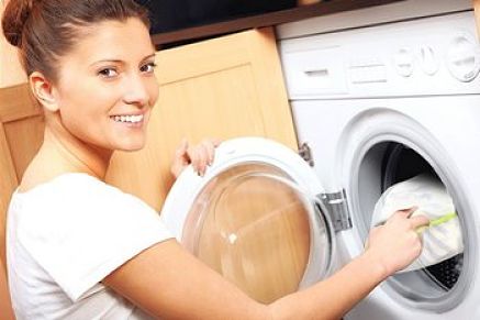 Donna inserisce nella lavatrice biancheria protetta dalla rete