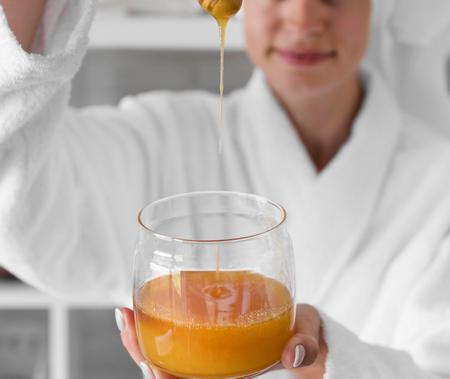 Donna sta per farsi una maschera facciale nutriente con il miele