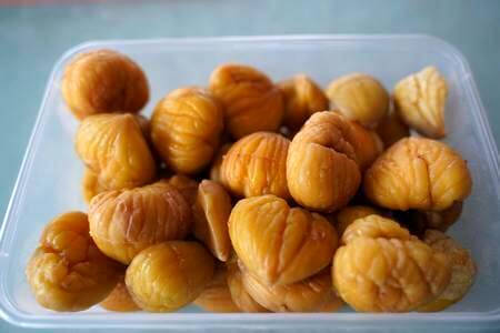 Castagne cotte, sbucciate e pelate dentro a vaschetta per alimenti